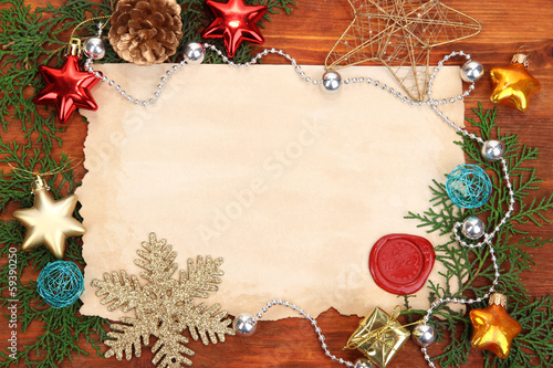 Photo: Frame with vintage paper and Christmas decorations Frame with vintage paper and Christmas decorations