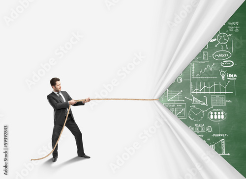 Photo: young man pulling rope young man pulling rope