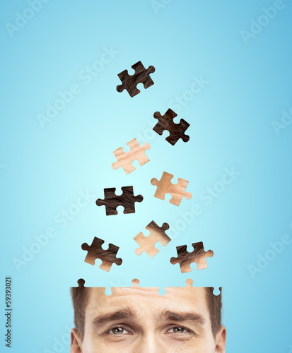 Photo: head businessman built of puzzle head businessman built of puzzle