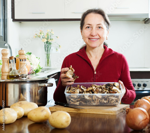 Photo: mature woman with dried mushrooms mature woman with dried mushrooms