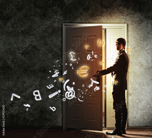 Photo: Young businessman opening door Young businessman opening door