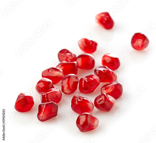 Photo: pomegranate seeds on a white background pomegranate seeds on a white background