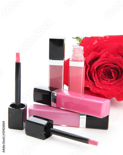 Photo: Beautiful lip glosses, isolated on white Beautiful lip glosses, isolated on white