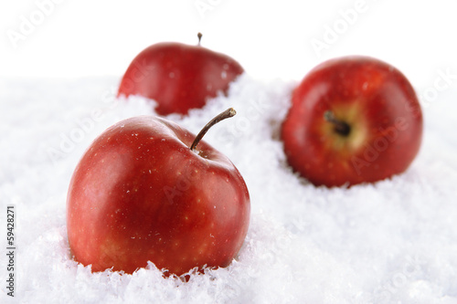 Photo: Red apples in snow isolated on white Red apples in snow isolated on white
