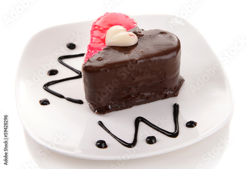 Photo: Sweet cake with chocolate on plate isolated on white Sweet cake with chocolate on plate isolated on white