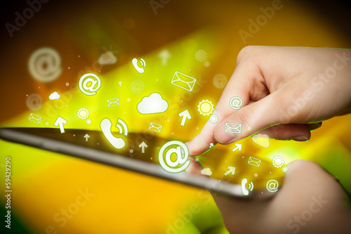 Photo: Hand touching tablet pc, social media concept Hand touching tablet pc, social media concept