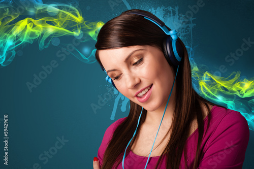 Photo: Young woman listening to music with headphones Young woman listening to music with headphones