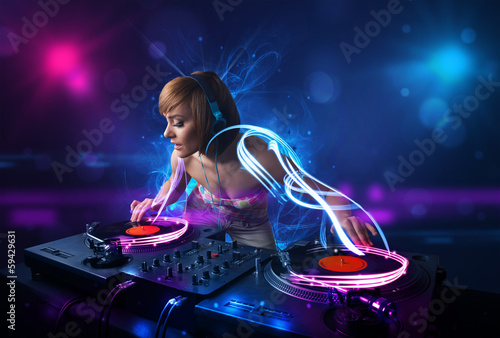 Photo: Disc jockey playing music with electro light effects and lights Disc jockey playing music with electro light effects and lights