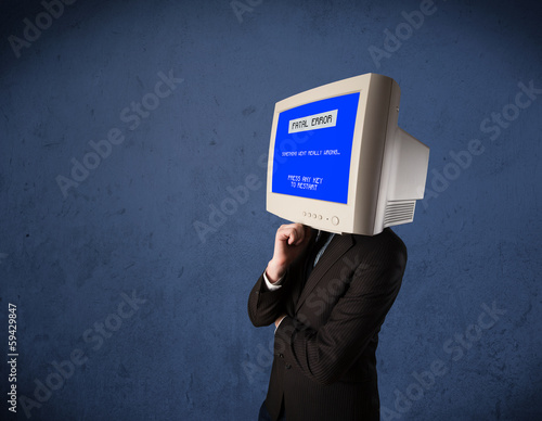 Photo: Person with a monitor head and fatal error blue screen on the di Person with a monitor head and fatal error blue screen on the di