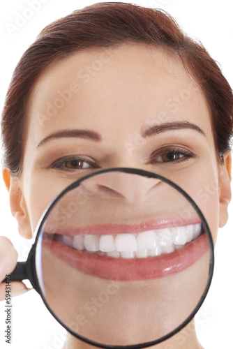 Photo: Beautiful young woman with magnifying glass on mouth. Beautiful young woman with magnifying glass on mouth.
