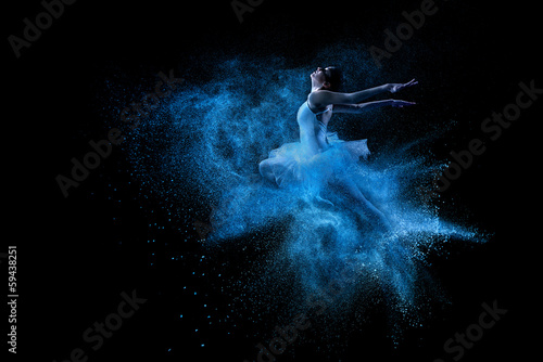 Fototapeta Young beautiful dancer jumping into blue powder cloud