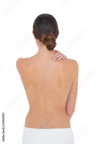 Photo: Rear view of a topless fit woman with shoulder pain Rear view of a topless fit woman with shoulder pain