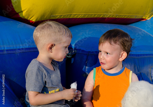Photo: Two cute little boys enjoying cotton candy Two cute little boys enjoying cotton candy