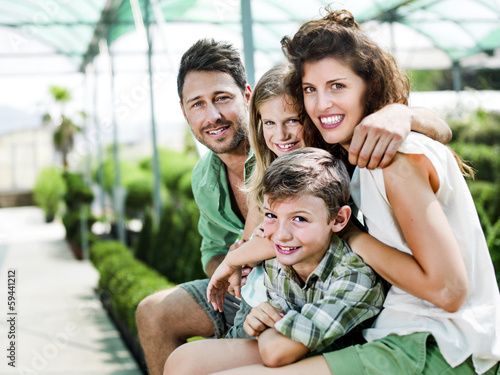 Photo: family having fun in a greenhouse family having fun in a greenhouse