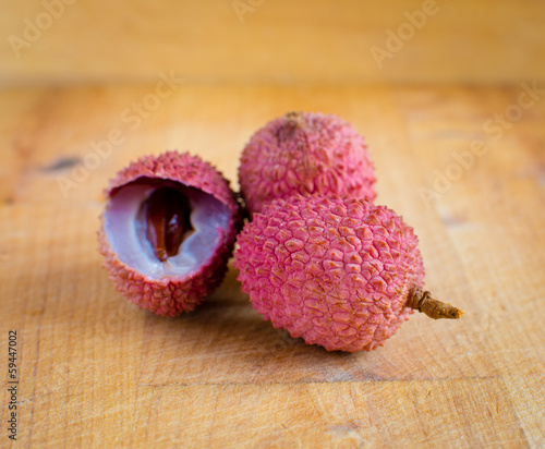 Photo: Lychee on a wooden table. Lychee on a wooden table.