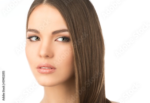 Photo: Beautiful young girl with long hair isolated on white Beautiful young girl with long hair isolated on white