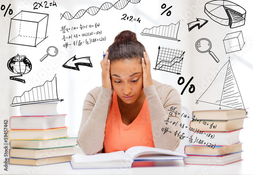 Photo: tired student with books and notes tired student with books and notes