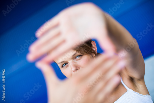 Photo: Pretty, young woman making a photo composing Pretty, young woman making a photo composing