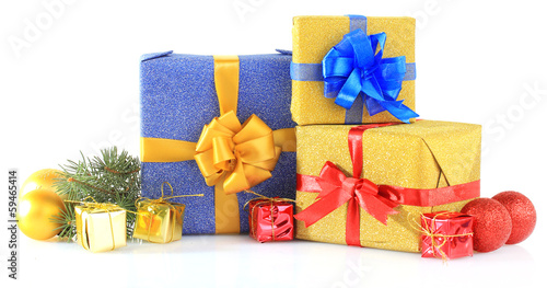 Photo: Beautiful bright gifts and christmas decor, isolated on white Beautiful bright gifts and christmas decor, isolated on white