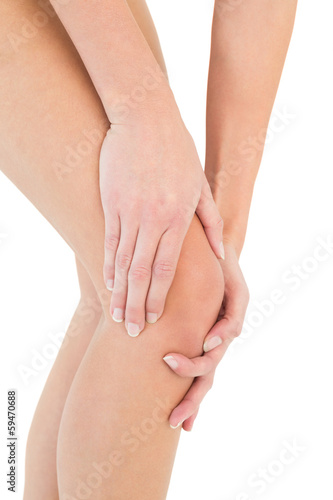 Photo: Close-up mid section of a woman with knee pain Close-up mid section of a woman with knee pain