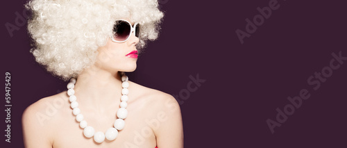 Photo: Beautiful sexy woman in a blond afro wig Beautiful sexy woman in a blond afro wig