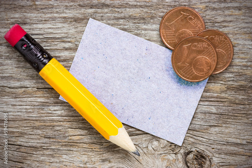 Photo: Coins with pencil and paper card Coins with pencil and paper card