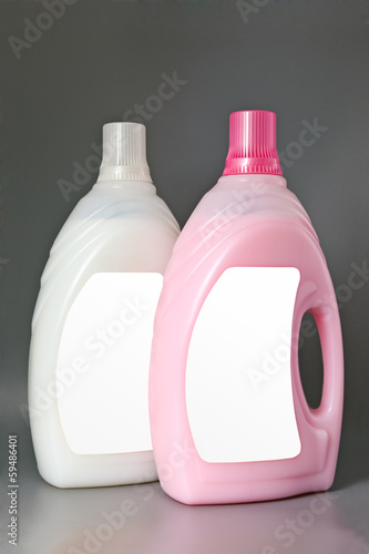 Photo: Transparent detergent plastic bottle isolated on gray Transparent detergent plastic bottle isolated on gray