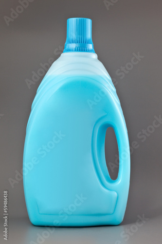 Photo: Transparent detergent plastic bottle isolated on gray Transparent detergent plastic bottle isolated on gray