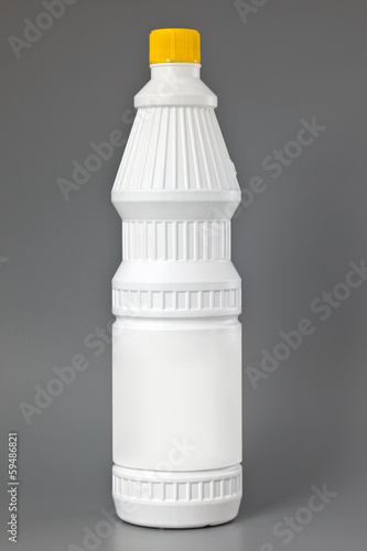 Photo: White detergent plastic bottle isolated on gray White detergent plastic bottle isolated on gray