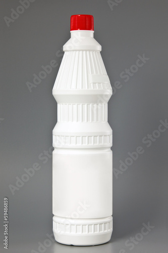 Photo: White detergent plastic bottle isolated on gray White detergent plastic bottle isolated on gray