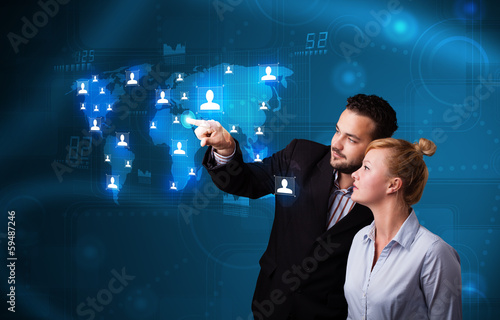 Photo: Young couple choosing from social network map Young couple choosing from social network map