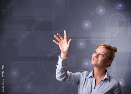 Photo: Young businesswoman touching copy space Young businesswoman touching copy space