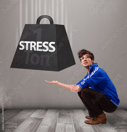 Photo: Handsome boy holding one ton of stress weight Handsome boy holding one ton of stress weight