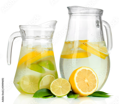 Photo: Cold water with lime, lemon and ice in pitchers isolated Cold water with lime, lemon and ice in pitchers isolated