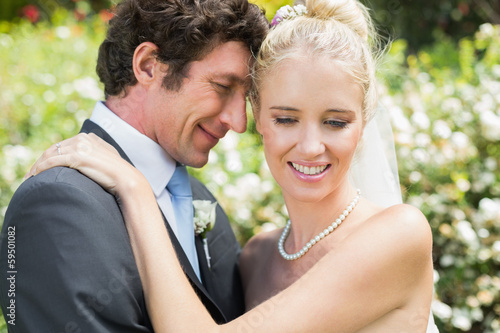 Photo: Romantic attractive newlyweds hugging each other Romantic attractive newlyweds hugging each other