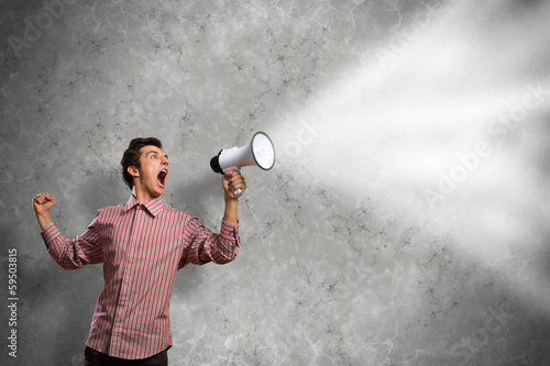 Photo: man yells into a megaphone man yells into a megaphone