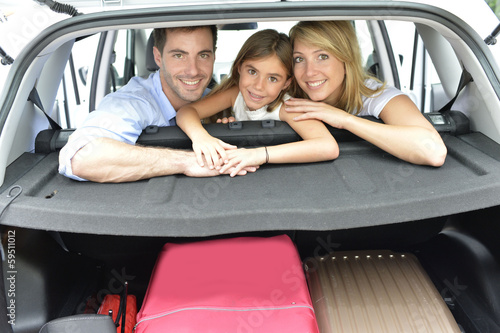 Photo: Cheerful family of three ready for vacation Cheerful family of three ready for vacation