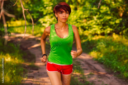 Photo: beautiful a healthy runs brunette young woman athlete running ou beautiful a healthy runs brunette young woman athlete running ou