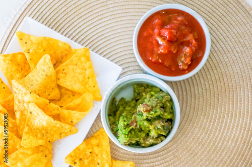 Photo: Mexican nachos. Homemade mexican salsas with corn chips Mexican nachos. Homemade mexican salsas with corn chips