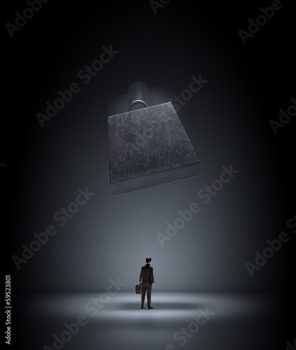 Illustration: Huge wieght falling on a businessman Huge wieght falling on a businessman