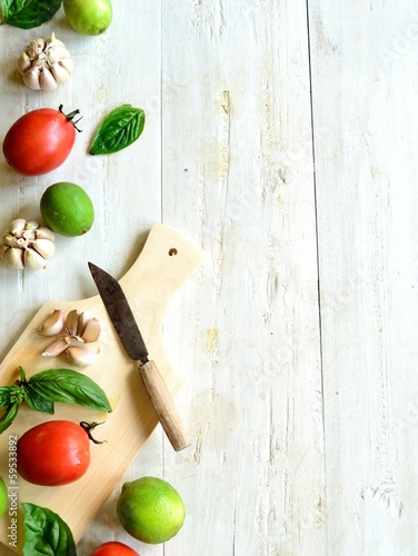 Photo: Tomato,basil and garlic with cutting board Tomato,basil and garlic with cutting board