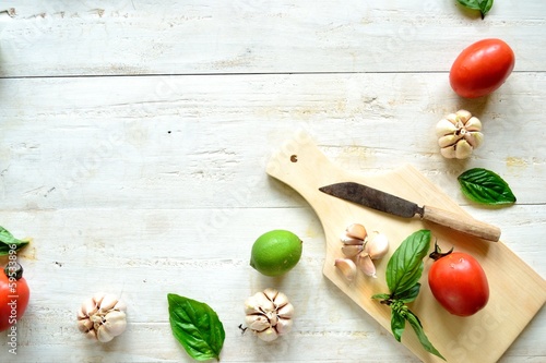 Photo: Tomato,basil and garlic with cutting board Tomato,basil and garlic with cutting board