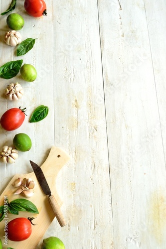 Photo: Tomato,basil and garlic with cutting board Tomato,basil and garlic with cutting board