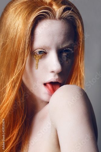 Photo: Eccentric Woman Licking Shoulder. Painted Skin. Gold Tears Eccentric Woman Licking Shoulder. Painted Skin. Gold Tears