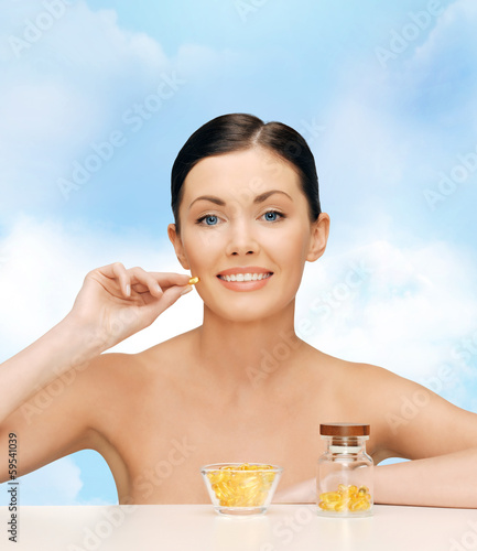 Photo: beautiful woman with omega 3 vitamins beautiful woman with omega 3 vitamins