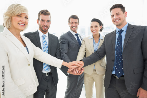 Photo: Business team joining hands together Business team joining hands together