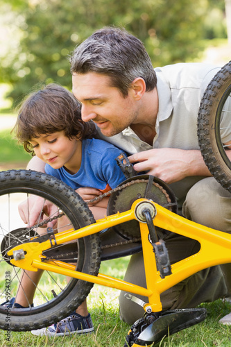 Photo: Father and son fixing bike Father and son fixing bike