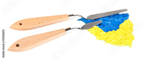 Photo: Painting palette knifes with paint isolated on white Painting palette knifes with paint isolated on white