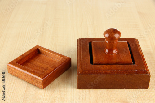 Photo: Wooden stamp on wooden background Wooden stamp on wooden background