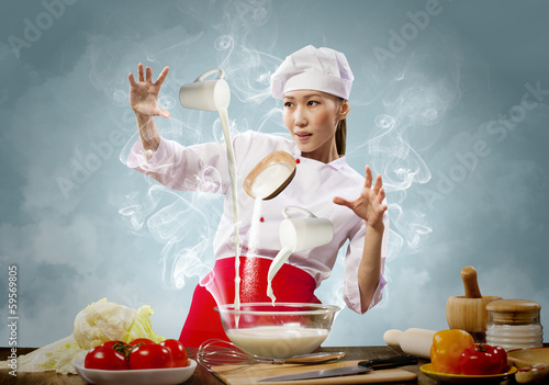 Photo: Asian female cooking with magic Asian female cooking with magic